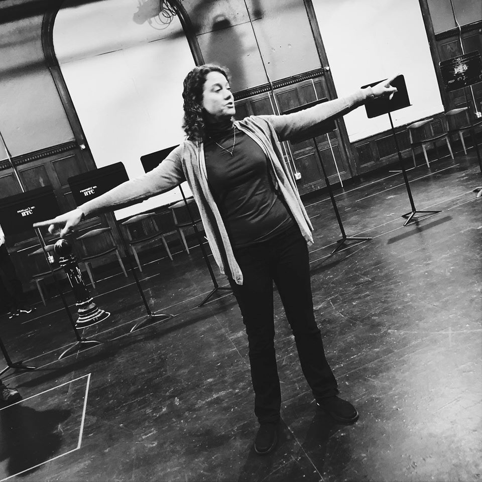 Photo of Emily describing the set in the rehearsal hall